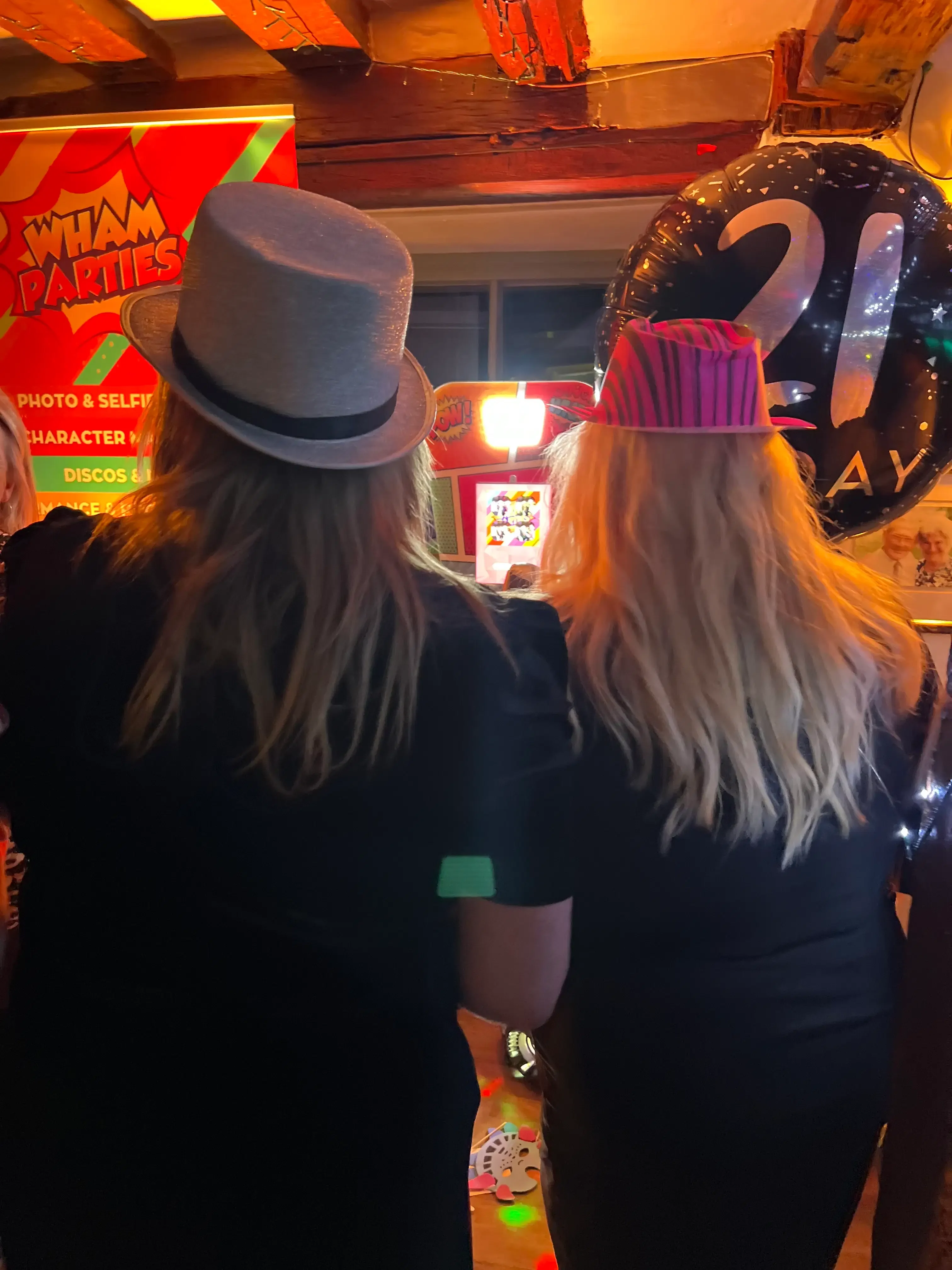 Guests enjoying a WHAM photo booth at a 21st birthday